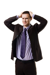 Image showing Very upset young man holding head with hands wearing formal suit