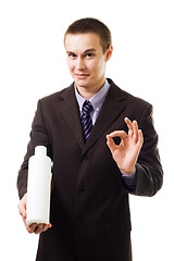 Image showing Young businessman advertise new product holding blank bottle