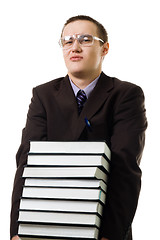 Image showing Young man carry pile of books