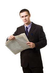 Image showing Young man reading newspaper standing 