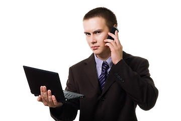 Image showing Young handsome man with cell phone and laptop