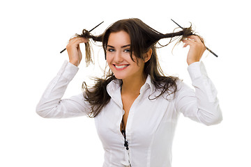 Image showing woman twirl her hair with sticks