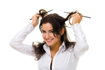 Image showing woman twirl her hair with sticks