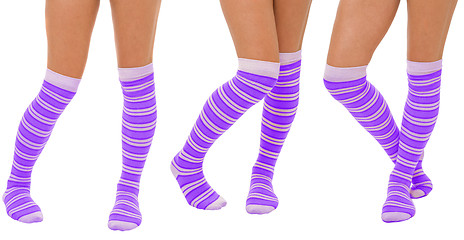 Image showing Pairs of women legs in purple socks