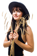 Image showing woman with bunch of wheat in blue hat smile