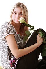 Image showing Girl sitting with yellow rose