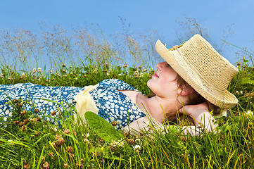 Image showing Young girl resting in meadow