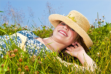 Image showing Young girl laying on meadow