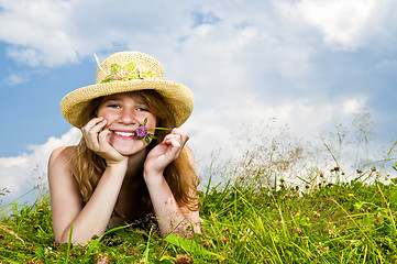 Image showing Young girl laying in meadow