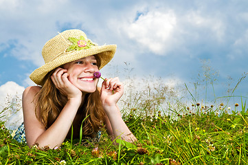 Image showing Young girl laying in meadow