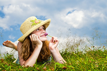 Image showing Young girl laying in meadow