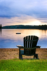 Image showing Wooden chair at sunset on beach