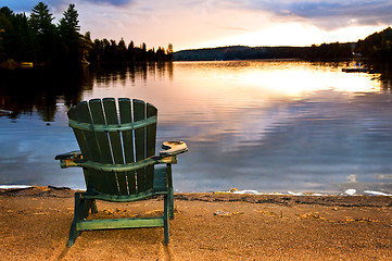 Image showing Wooden chair at sunset on beach