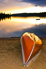 Image showing Lake sunset with canoe on beach