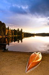 Image showing Lake sunset with canoe on beach