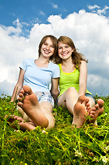 Image showing Young girls sitting in meadow