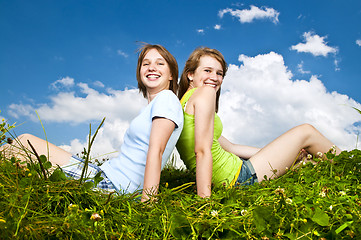 Image showing Young girls sitting in meadow