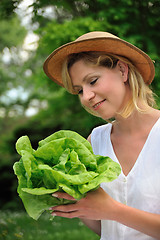 Image showing Young woman holding fresh lettuce