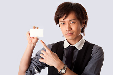 Image showing Asian business man pointing at white card