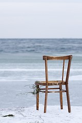 Image showing Chair washed ashore and facing the ocean