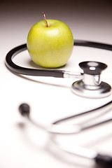 Image showing Stethoscope and Green Apple on Gradated Background