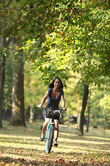 Image showing Woman riding a bicycle