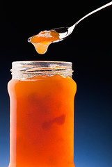 Image showing apricot jam and tea spoon