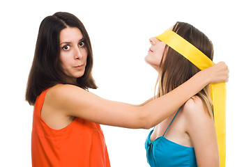 Image showing Two young women play blind