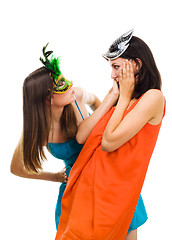 Image showing Two surprised young women wearing mask at masquerade party