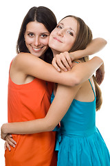 Image showing Two young woman embrace and smile