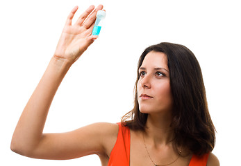 Image showing Woman look on blue test tube and thinking