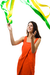Image showing Woman in vivid color dress play with flying ribbon