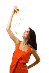 Image showing Young woman in orange dress with flying