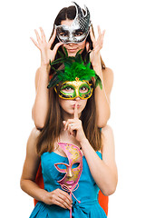 Image showing Two young women in masks make hush sign