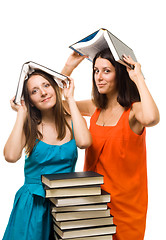 Image showing Two young student woman play with books 