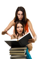 Image showing wo shocked woman look into book