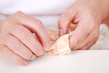 Image showing Elderly woman sewing