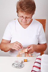 Image showing Elderly woman sewing