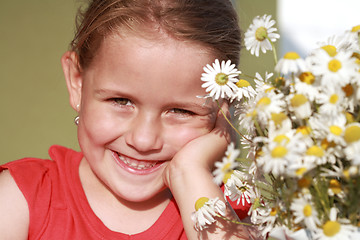 Image showing Little girl with chamomile