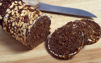 Image showing Pumpernickel bread slices and knife