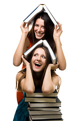 Image showing Two happy women with books together