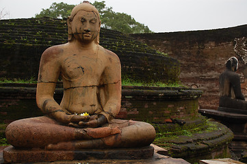 Image showing Seated Buddha Statues In The Rain