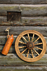 Image showing Ceramic Bottle And Spinning Wheel On The Wall