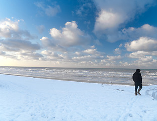 Image showing Man walking in snowy beach