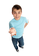 Image showing Casual boy holds a money box in palm of hand