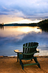 Image showing Wooden chair at sunset on beach