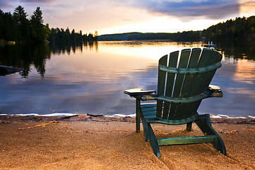 Image showing Wooden chair at sunset on beach