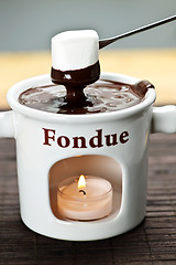 Image showing Marshmallow dipped in chocolate fondue