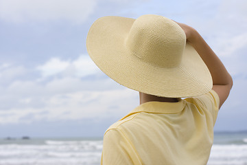 Image showing Woman with hat on a beach