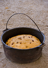 Image showing Bush cake in iron pot.